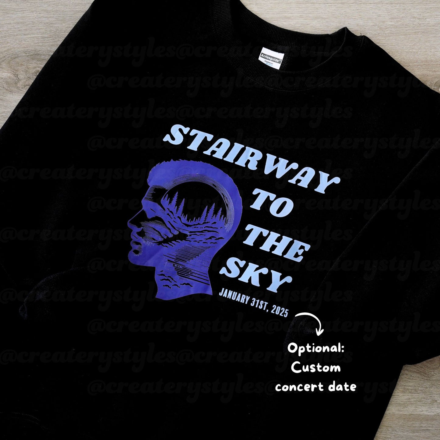 Black t-shirt with blue graphic and text 'Stairway to the Sky' on a wooden surface