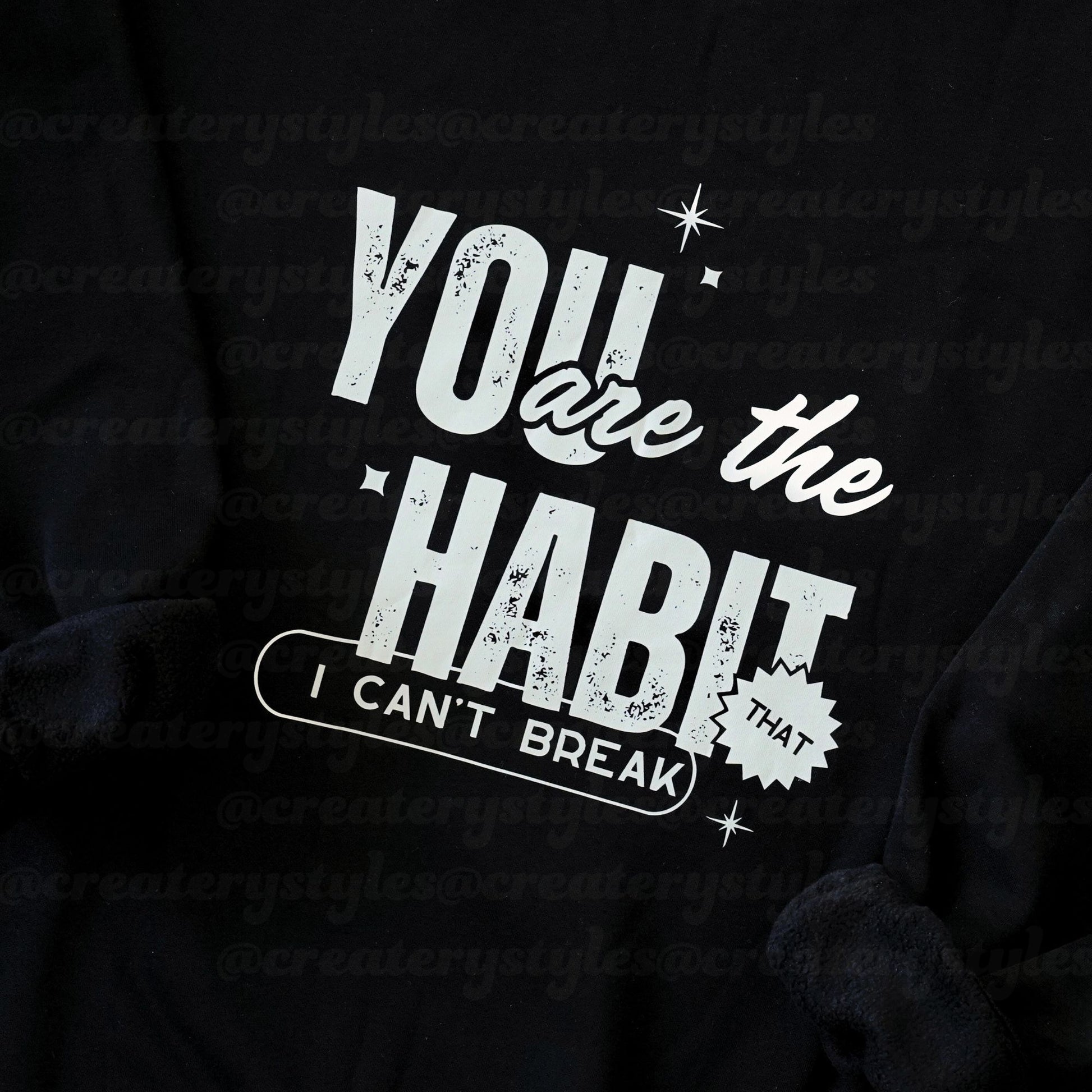 Black hoodie with white text 'You are the habit I can't break' on a black background