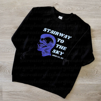 Black sweatshirt with blue graphic and text on a wooden surface