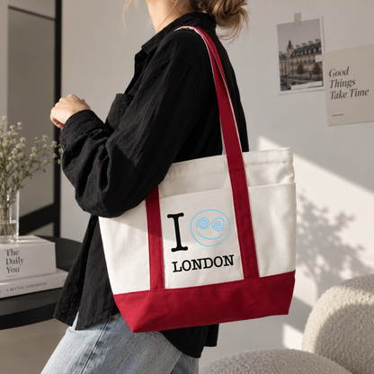 Red custom city canvas tote bag with London text and blue snail design worn over the shoulder
