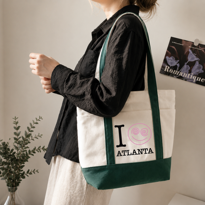 Green personalized canvas tote bag with Atlanta city text and pink snail graphic