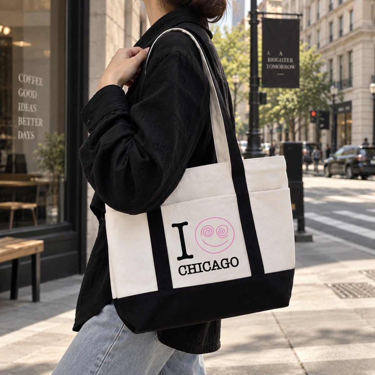 Black custom city canvas tote bag with Chicago text and pink snail mail design worn on the shoulder